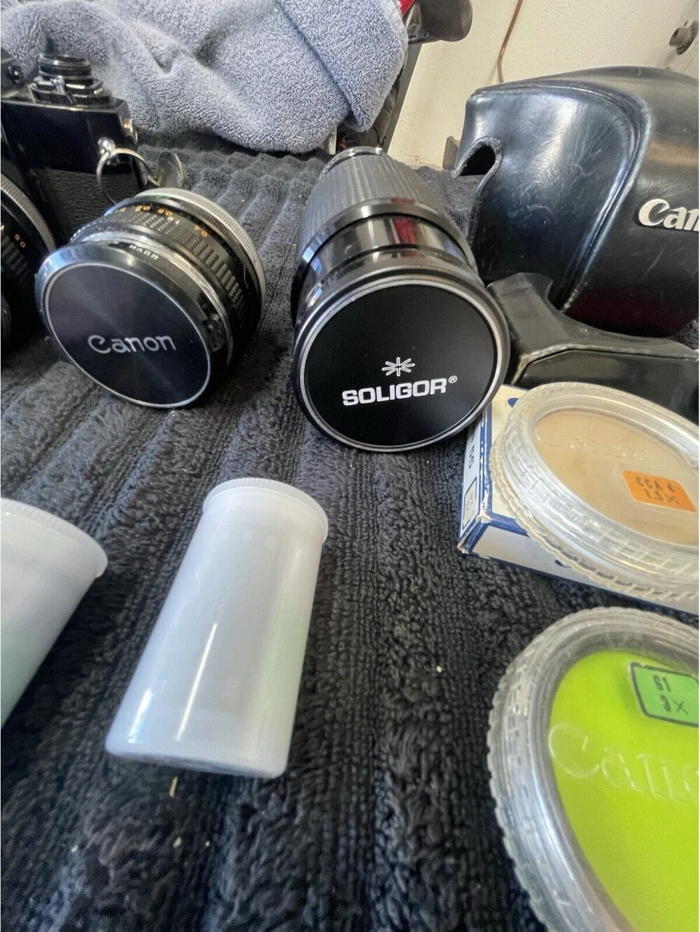 CANON F-1 FILM CAMERA WITH LENSES, CASE, FILM AND MORE  *TESTED, READ DESC*